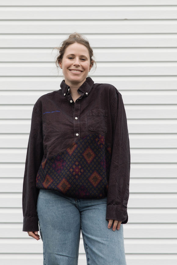 Person wearing a dark brown shirt with a patterned upcycled in canada