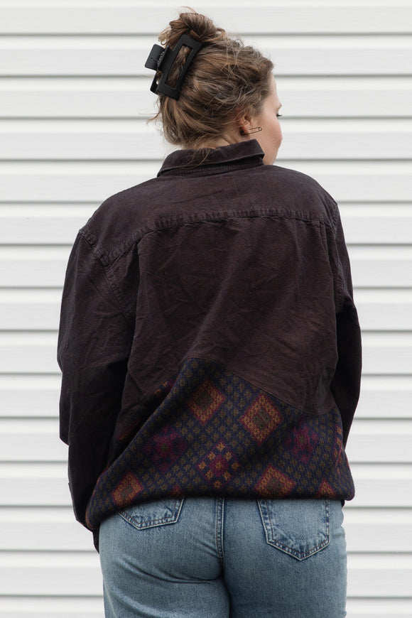 Person wearing a dark brown shirt with a patterned upcycled in canada