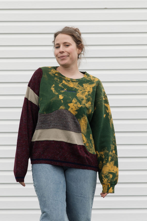 Person wearing a colorful sweater with a patterned design, upcycled in canada