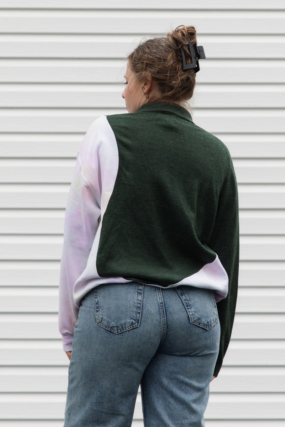 person wearing an upcycled sweater, featuring a green plaid knit sweater and pink tie dyed sweater sewn together, upcycled in canada