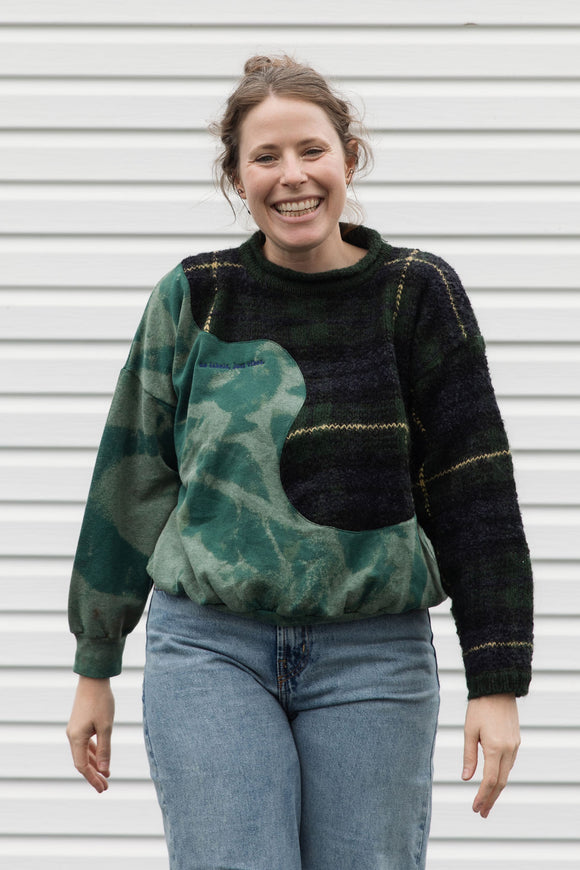 person wearing an upcycled sweater that is bleached and plaid, made in canada
