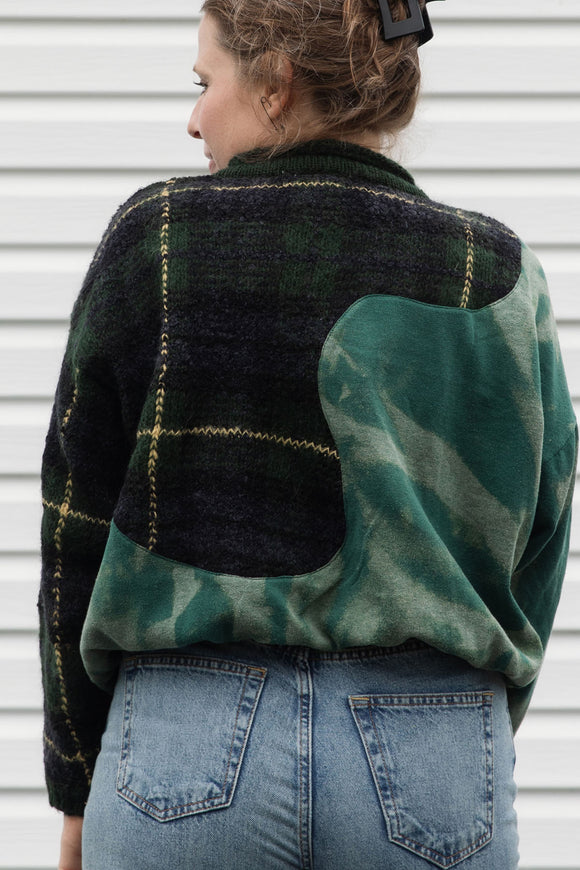 person wearing an upcycled sweater that is bleached and plaid, made in canada