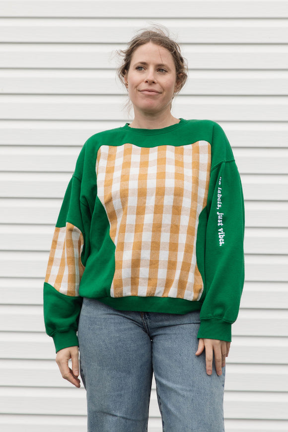 Person wearing a green and plaid sweater, upcycled in canada