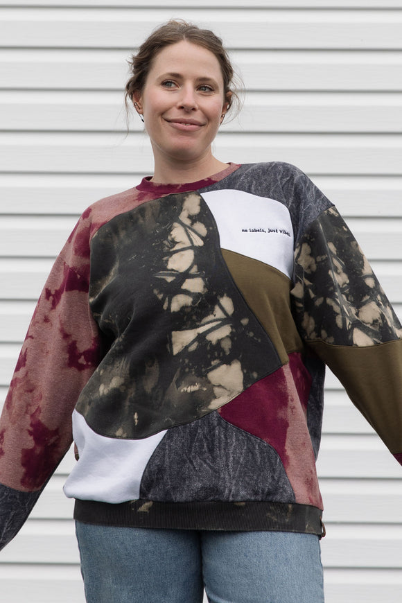 Woman wearing a colorful patterned patchwork sweater upcycled in canada