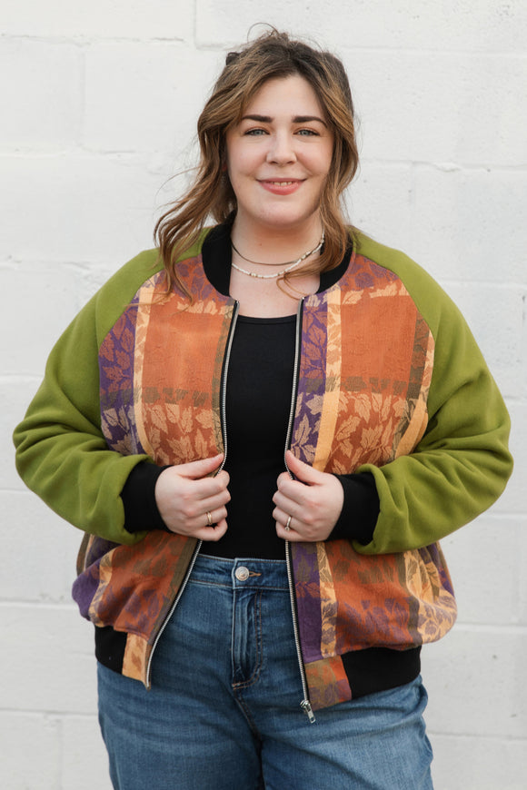 leafy table cloth upcycled into bomber jacket, orange, purrple and gold jacket with green sleeves, handmade in canada