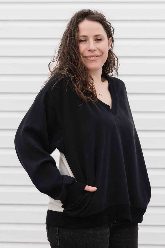 black v-neck slouchy blouse, with pockets, long sleeves & upcycled vintage fabric in the back. handmade in canada