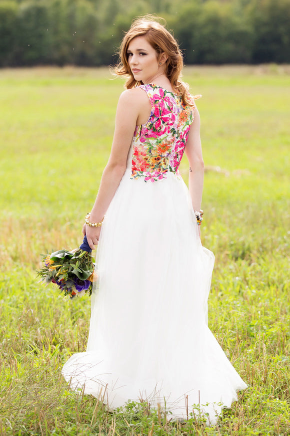 woman wearing an alternative wedding gown, white bodice with colourful floral lace in the back. cirnoline skirt, made in canada