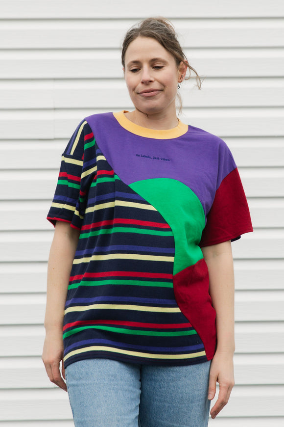 Person wearing a colorful striped shirt against a plain background