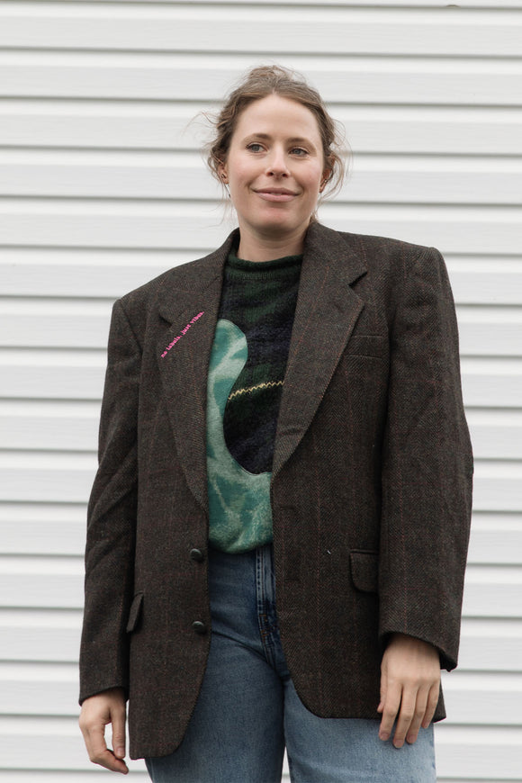person wearing a brown blazer with floral elbow patches, upcycled in canada