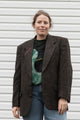 person wearing a brown blazer with floral elbow patches, upcycled in canada