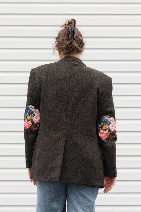 person wearing a brown blazer with floral elbow patches, upcycled in canada