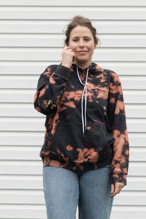 upcycled bleached hoodie with floral elbow patches