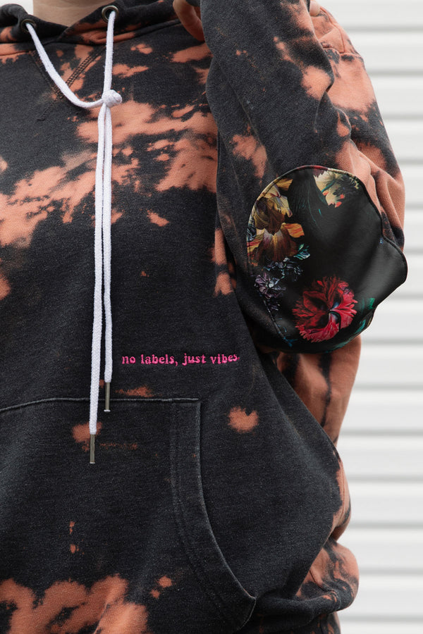 bleached sweater with floral elbow patches, embroidery with no labels, just vibes, upcycled in canada