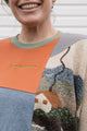 person wearing a one-of-a-kind patchwork sweater, featuring a knit cottage motif, upcycled in canada, detail shot featuring no labels, just vibes embroidery