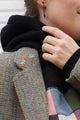 Person wearing a brown blazer with floral embroidery details upcycled in canada