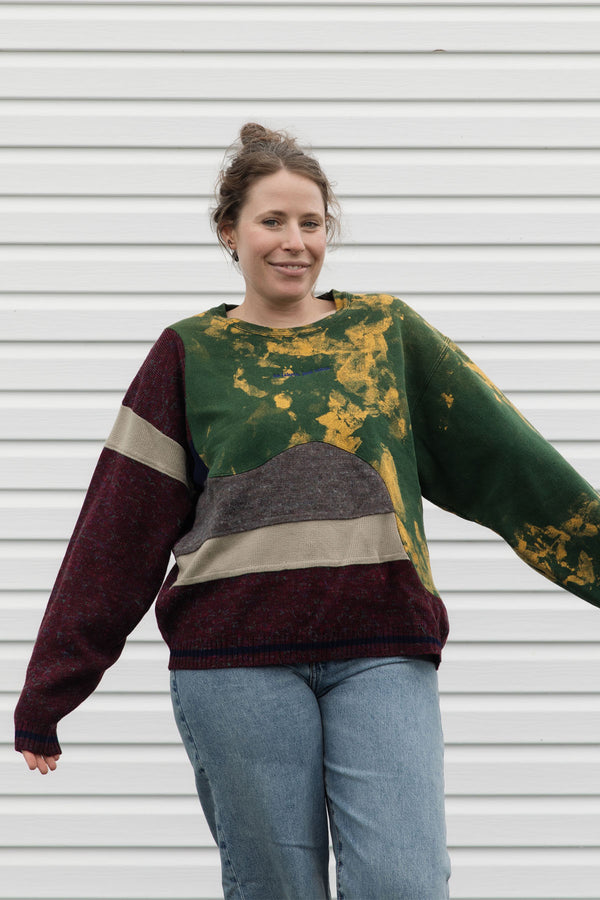 Person wearing a colorful sweater with a patterned design, upcycled in canada