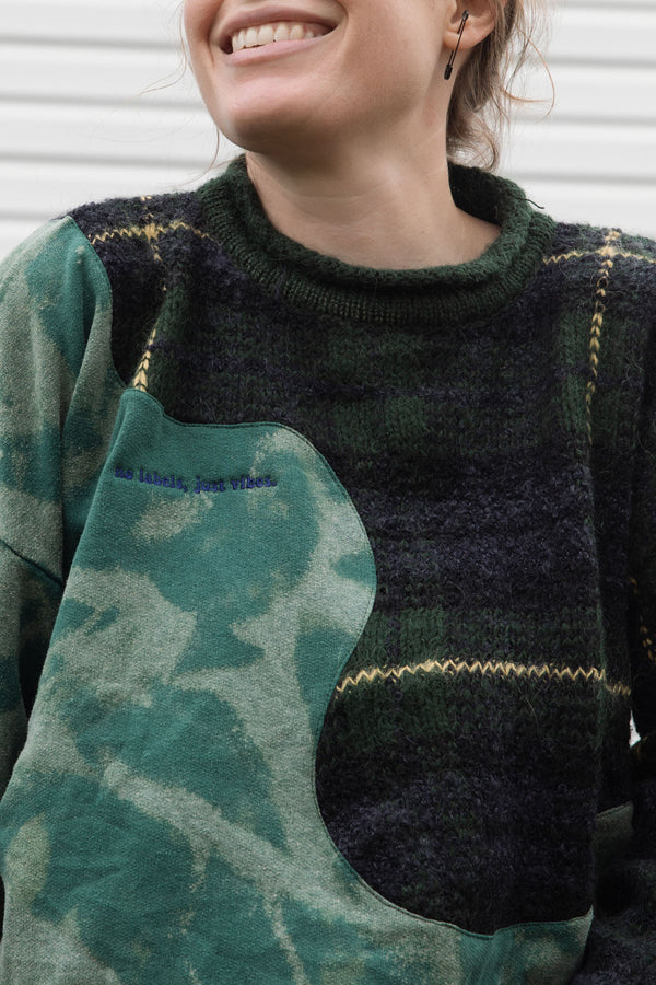 person wearing an upcycled sweater that is bleached and plaid, made in canada