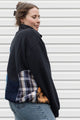 person wearing black half zip with lots of colour details and patterns, upcycled in canada