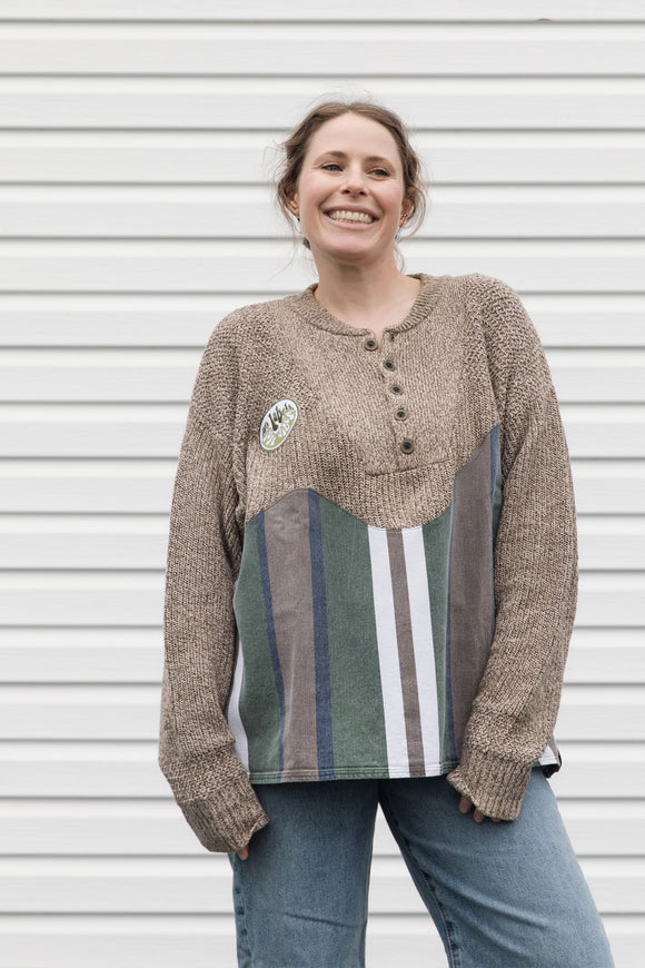 person wearing oversized brown knit with striped bottom, upcycled in canada