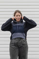 person is wearing a two tone navy hoodie, upcycled in canada