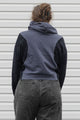 person is wearing a two tone navy hoodie, upcycled in canada