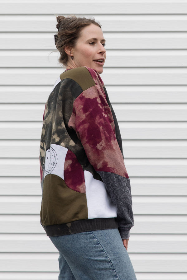 Woman wearing a colorful patterned patchwork sweater upcycled in canada