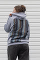 person wearing a grey hoodie with plaid inserts, upcycled in canada