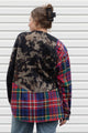 person wearing bleached sweater that is sewn together with red plaid shirt, upcycled in canada