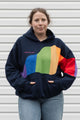 Person wearing a navy hoodie with a colourful rainbow design upcycled in canada