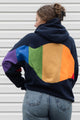 Person wearing a navy hoodie with a colourful rainbow design upcycled in canada