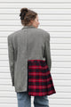 Person wearing a gray blazer sewn together with a red plaid skirt, upcycled in canada