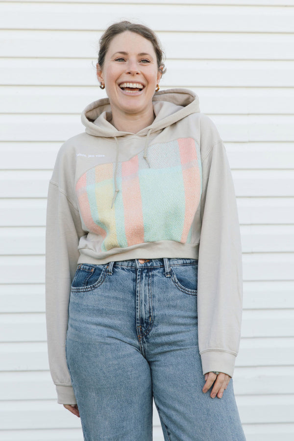 beige hoodie with pastel plaid throughout the front, upcycled in canada