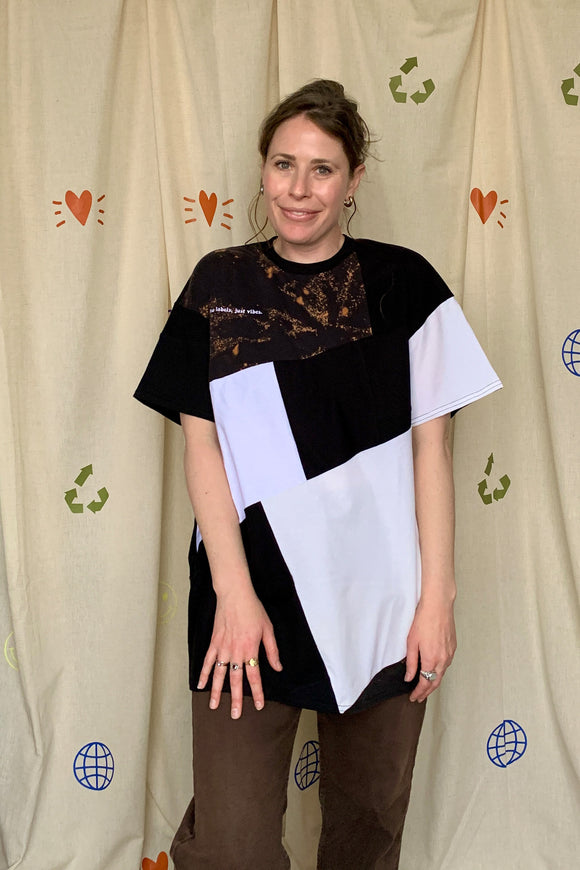 upcycled black, white & cream tshirt, with unique logo on the back, repurposed in canada