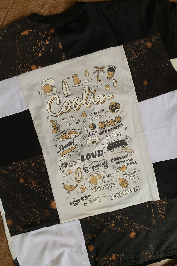 upcycled black, white & cream tshirt, with unique logo on the back, repurposed in canada