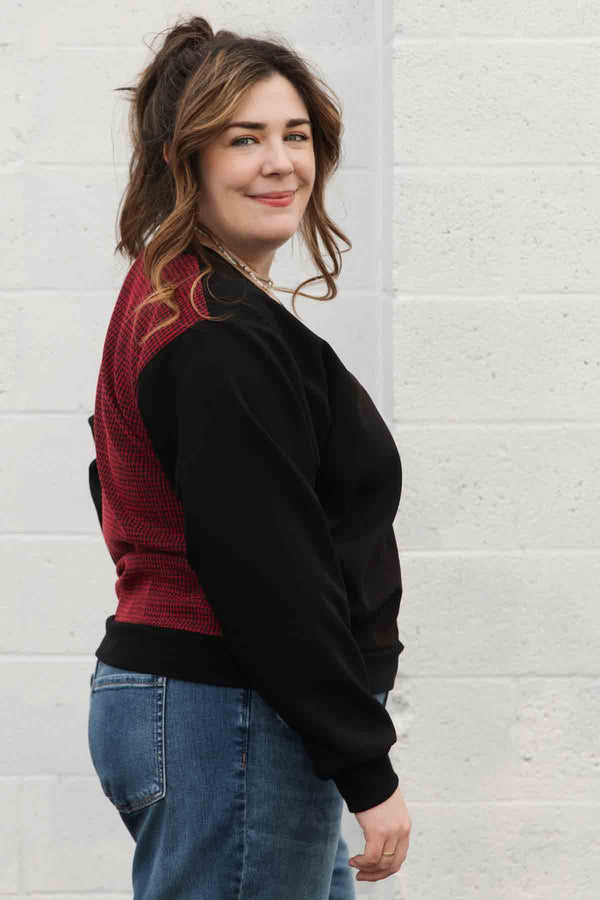 bomber blouse features a v-neck with pockets and a unique red check back fabric, handmade in canada