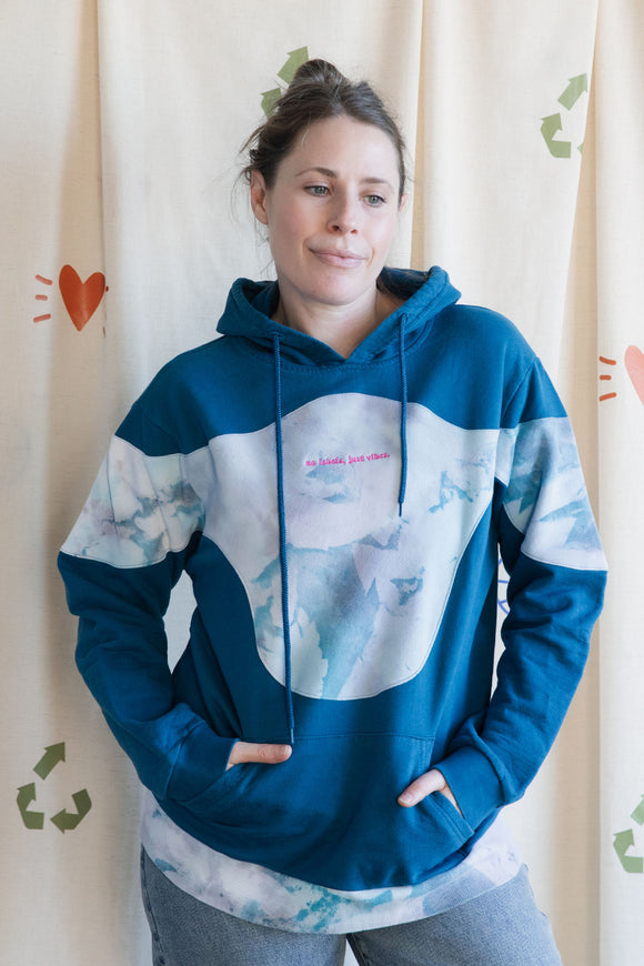 Person wearing a blue and tie-dye hoodie, upcycled in canada