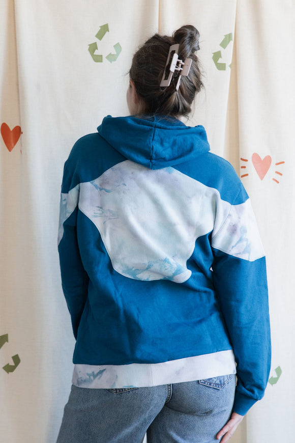 Person wearing a blue and tie-dye hoodie, upcycled in canada