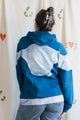 Person wearing a blue and tie-dye hoodie, upcycled in canada