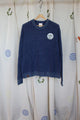 blue knit sweater with visible mending, upcycled in canada