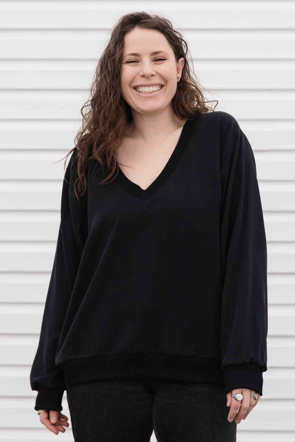 black v-neck slouchy blouse, with pockets, long sleeves & upcycled vintage fabric in the back. handmade in canada