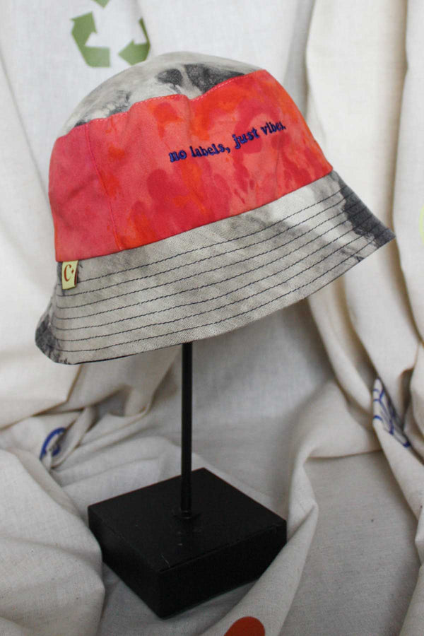 colourful upcycled bucket hat, each embroidered with 'no labels, just vibes.' and are reversible with solid colours, made in canada
