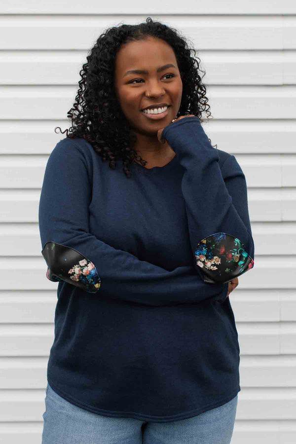 woman wearing a casual bamboo cotton sweater with floral elbow patches