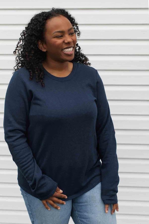 woman wearing a casual bamboo cotton sweater with floral elbow patches