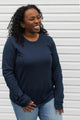 woman wearing a casual bamboo cotton sweater with floral elbow patches