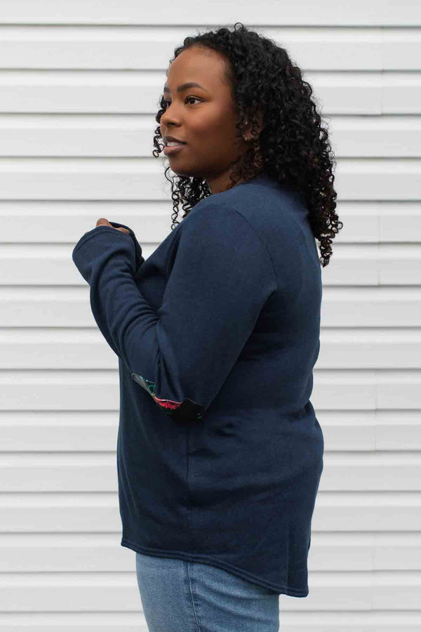 woman wearing a casual bamboo cotton sweater with floral elbow patches