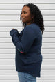 woman wearing a casual bamboo cotton sweater with floral elbow patches