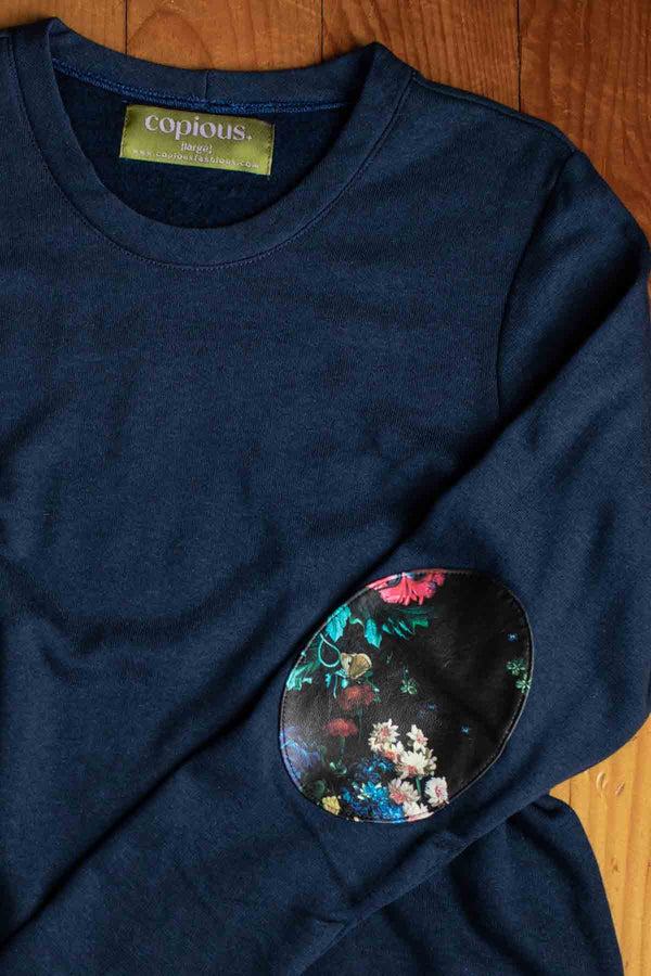 woman wearing a casual bamboo cotton sweater with floral elbow patches