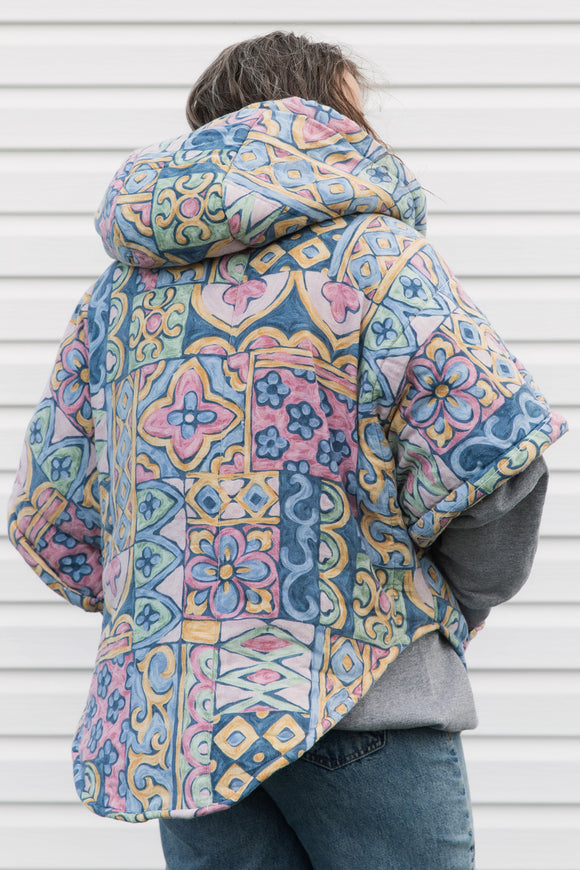 pastel printed comforter turned upcycled poncho, repurposed in canada