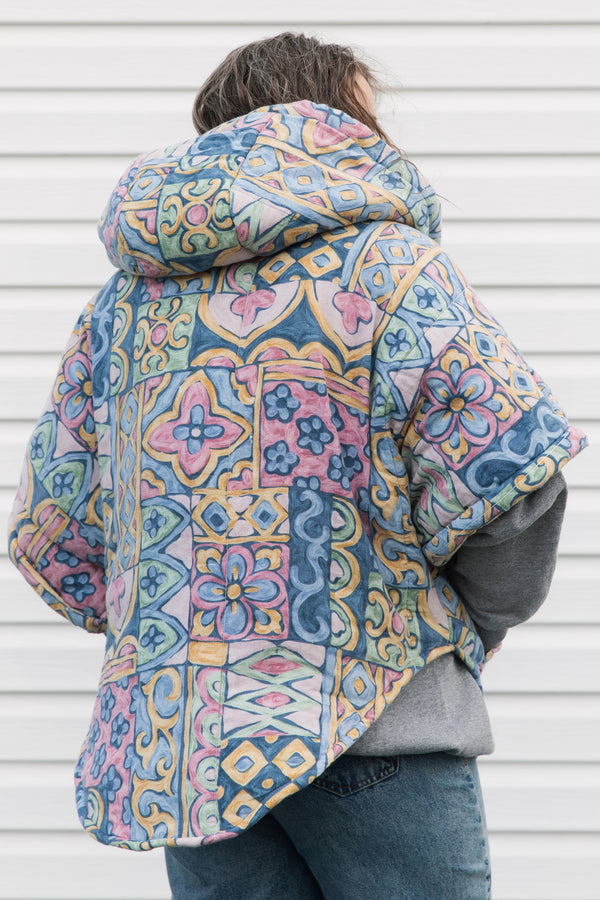 pastel printed comforter turned upcycled poncho, repurposed in canada