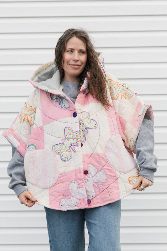 pink and white butterfly quilt turned poncho, featuring oversized hood, pockets and pretty purple buttons, repurposed in canada